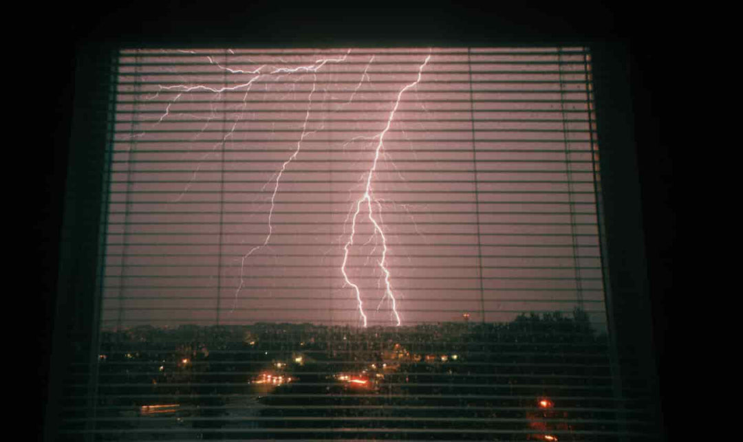 The Magic of Watching Thunderstorms Through Plastic Blinds