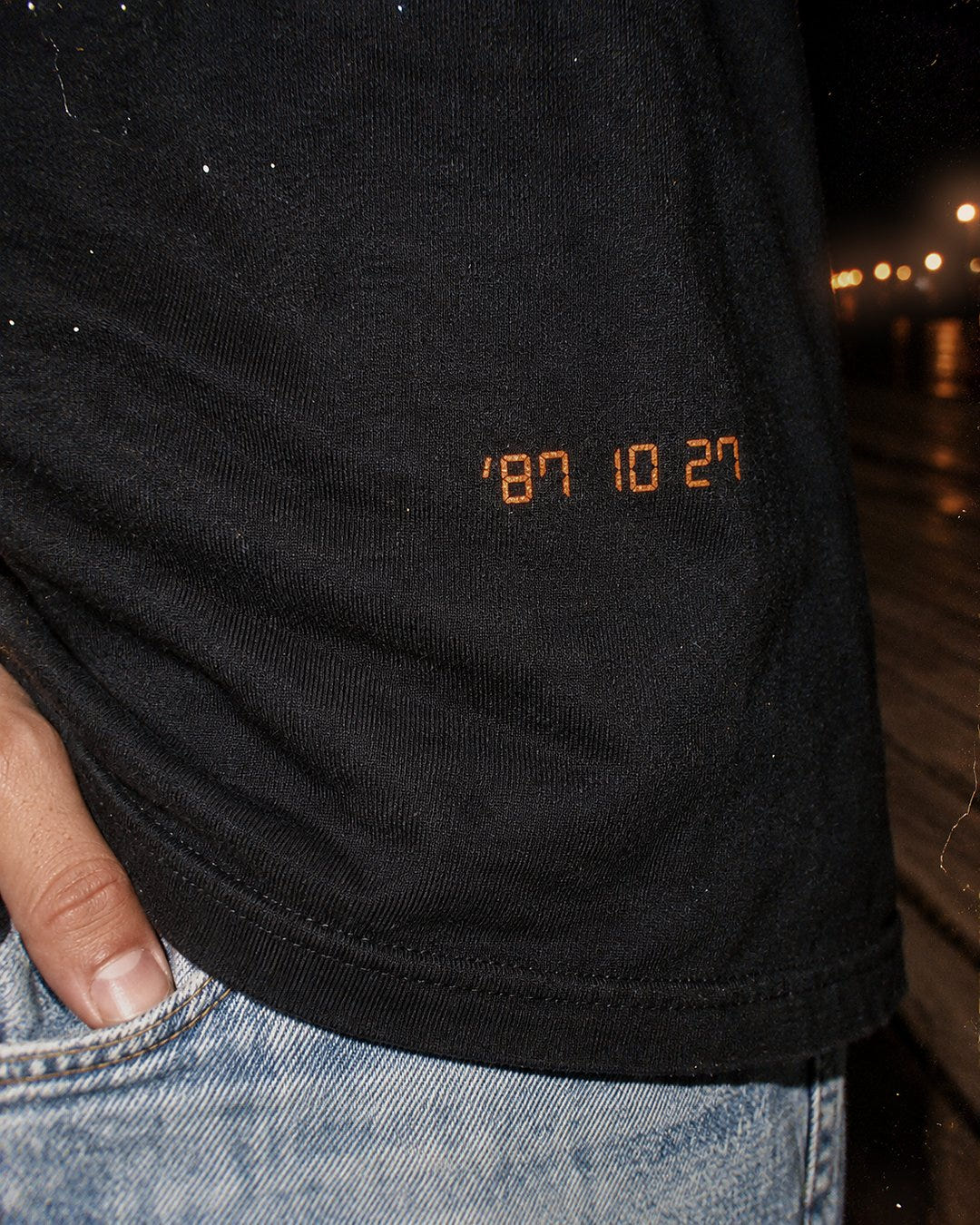 Close up of the orange 87 10 27 date stamp on the Date Stamp Tee 1987