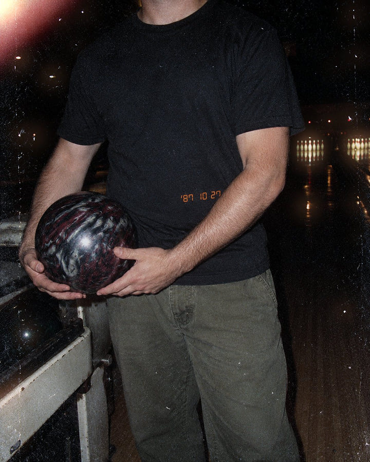 Date Stamp Tee 1987 at a bowling alley at night