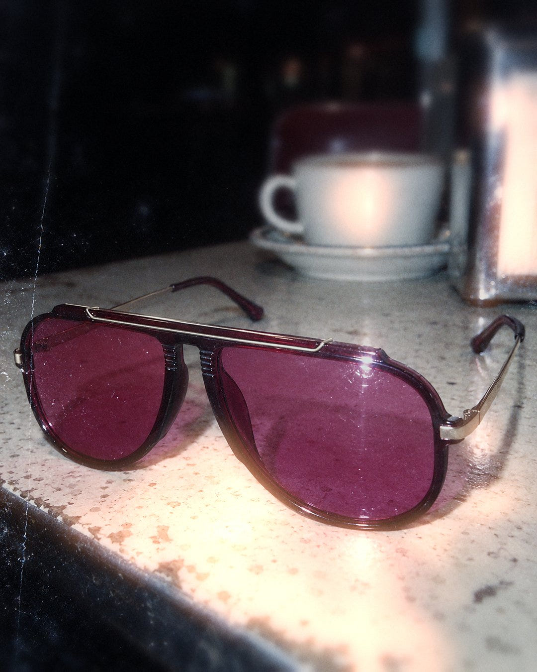 Magenta Pilot Sunglasses 1985 on a diner counter at night