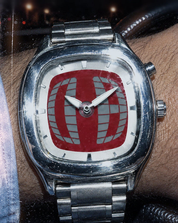 Red Grid Watch 1985 on a wrist at the steering wheel at night